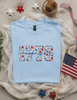 1776 America Floral Gildan Softstyle Tee by Ocean & 7th
