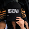 Misbehavin embroidered Trucker Hat by Madness & Mayhem LLC