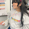 Maestra Papel Picado Embroidered Sweatshirt by Dog Mom Hat