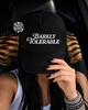 Barely tolerable embroidered Trucker Hat by Madness & Mayhem LLC