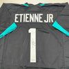 Autographed/Signed Travis Etienne Jr. Jacksonville Black Football Jersey Beckett BAS COA