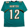 Autographed/Signed Travis Hunter Jacksonville Teal Retro Football Jersey Beckett BAS COA by Hall of Fame Sports Memorabilia