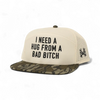 I Need a Hug from a Bad Bitch Snapback Hat by The Mad Hatter Company