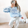 Living the Dream Graphic Sweatshirt by Hey Jude Graphic Tees